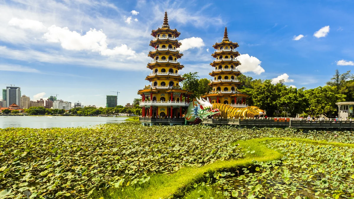 Dragon and Tiger Pagodas rising above the lotus-covered lake