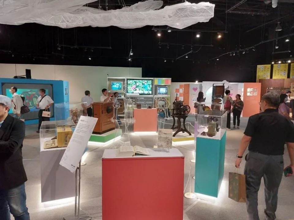 Visitors exploring communication technology displays inside the science museum